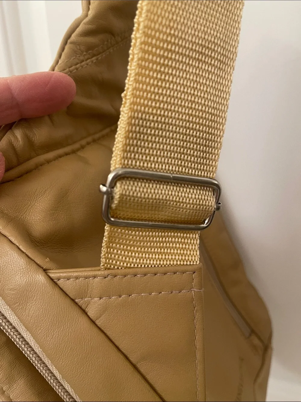 Buxton tan crossbody sling backpack